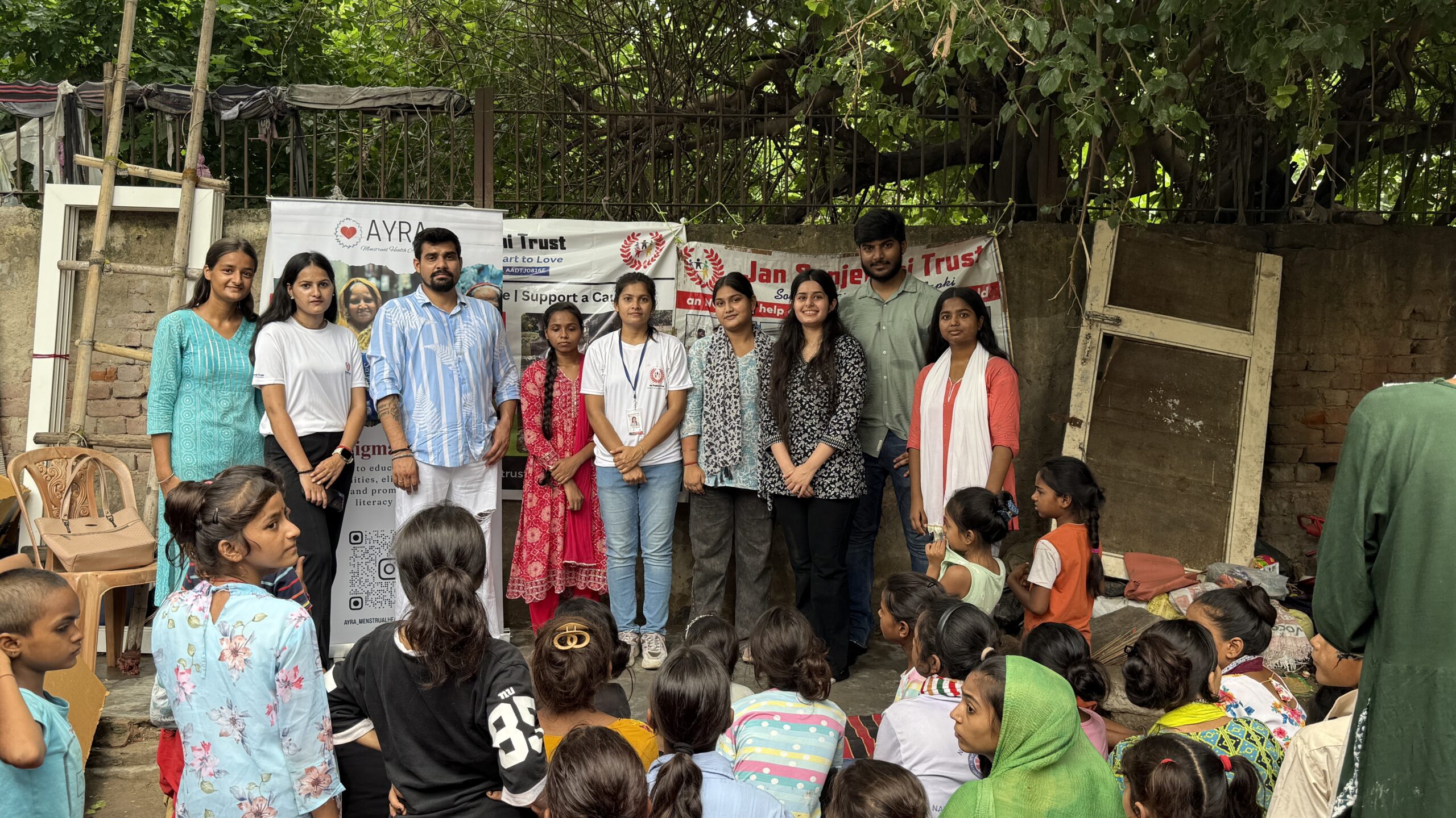 NGO volunteers distributing sanitary pads to women in rural India