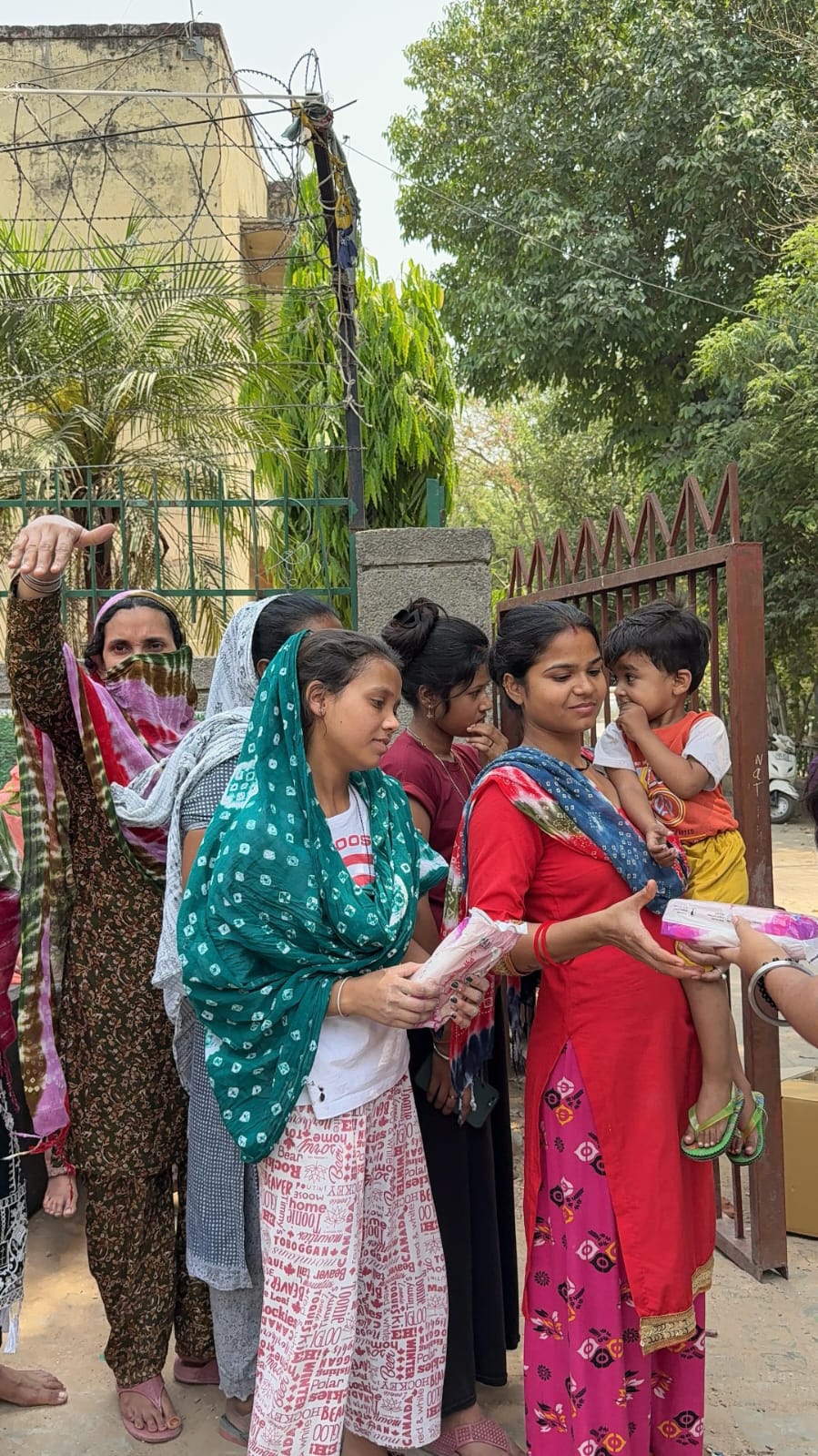 Women receiving sanitary pad kits from NGO during awareness drive