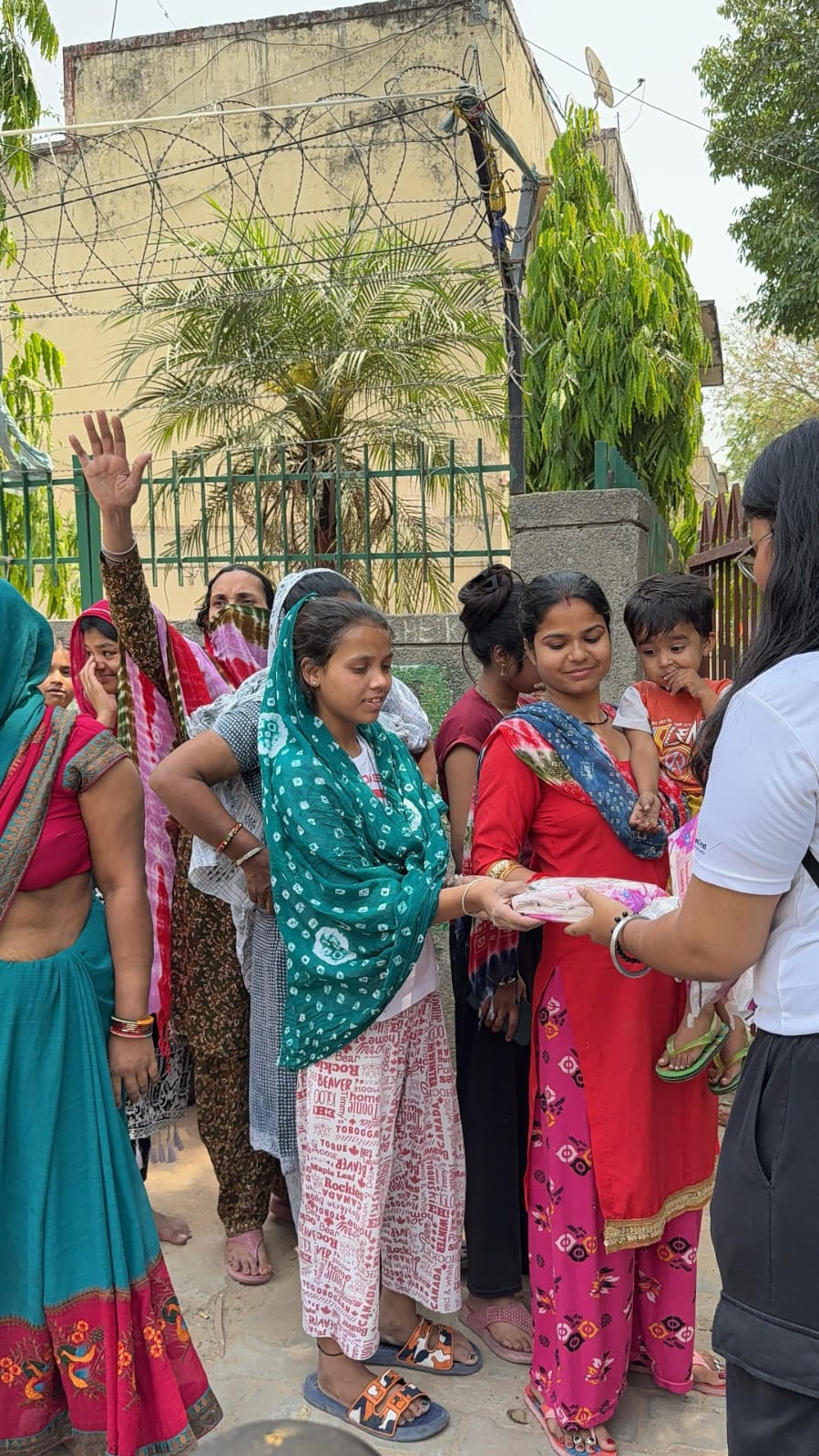Women receiving sanitary pad kits from NGO during awareness drive