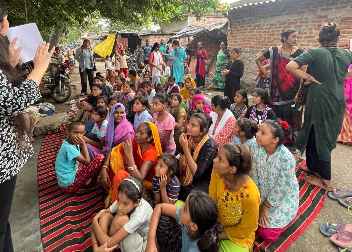 NGO volunteers conducting sanitary pad awareness workshop in community