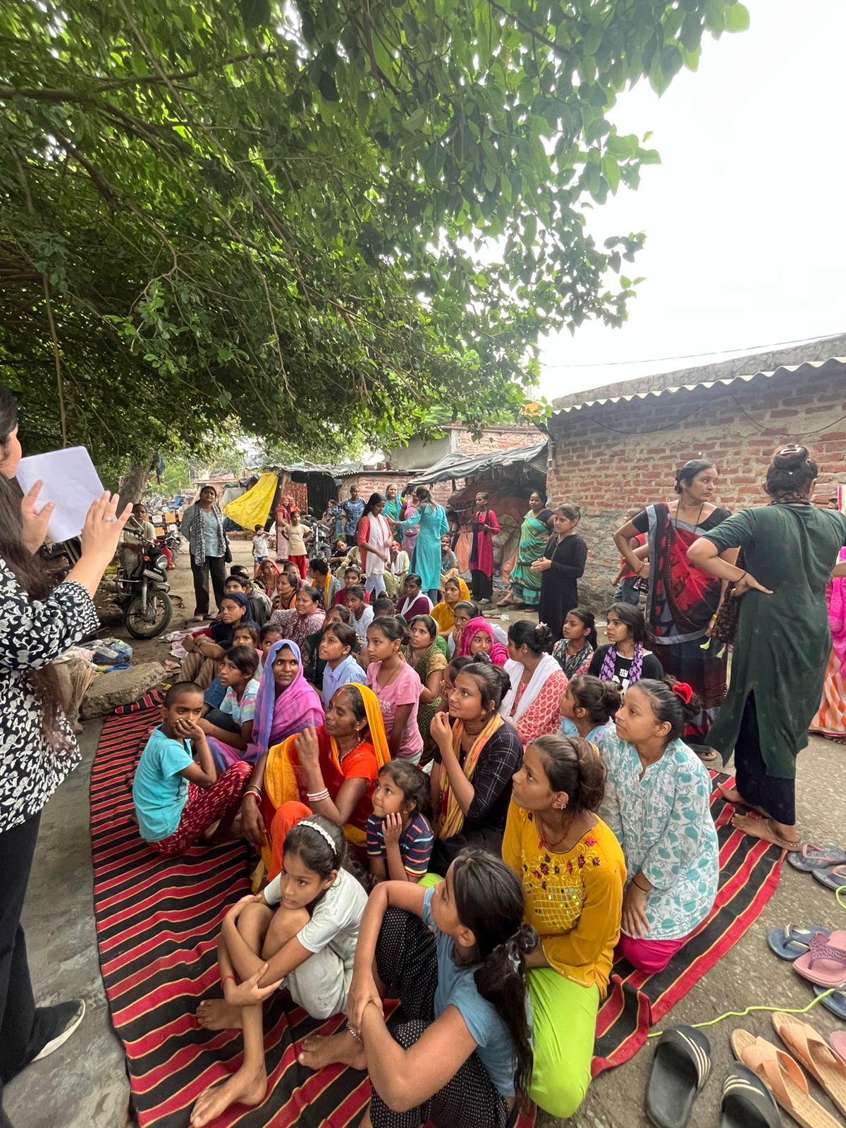 NGO volunteers conducting sanitary pad awareness workshop in community