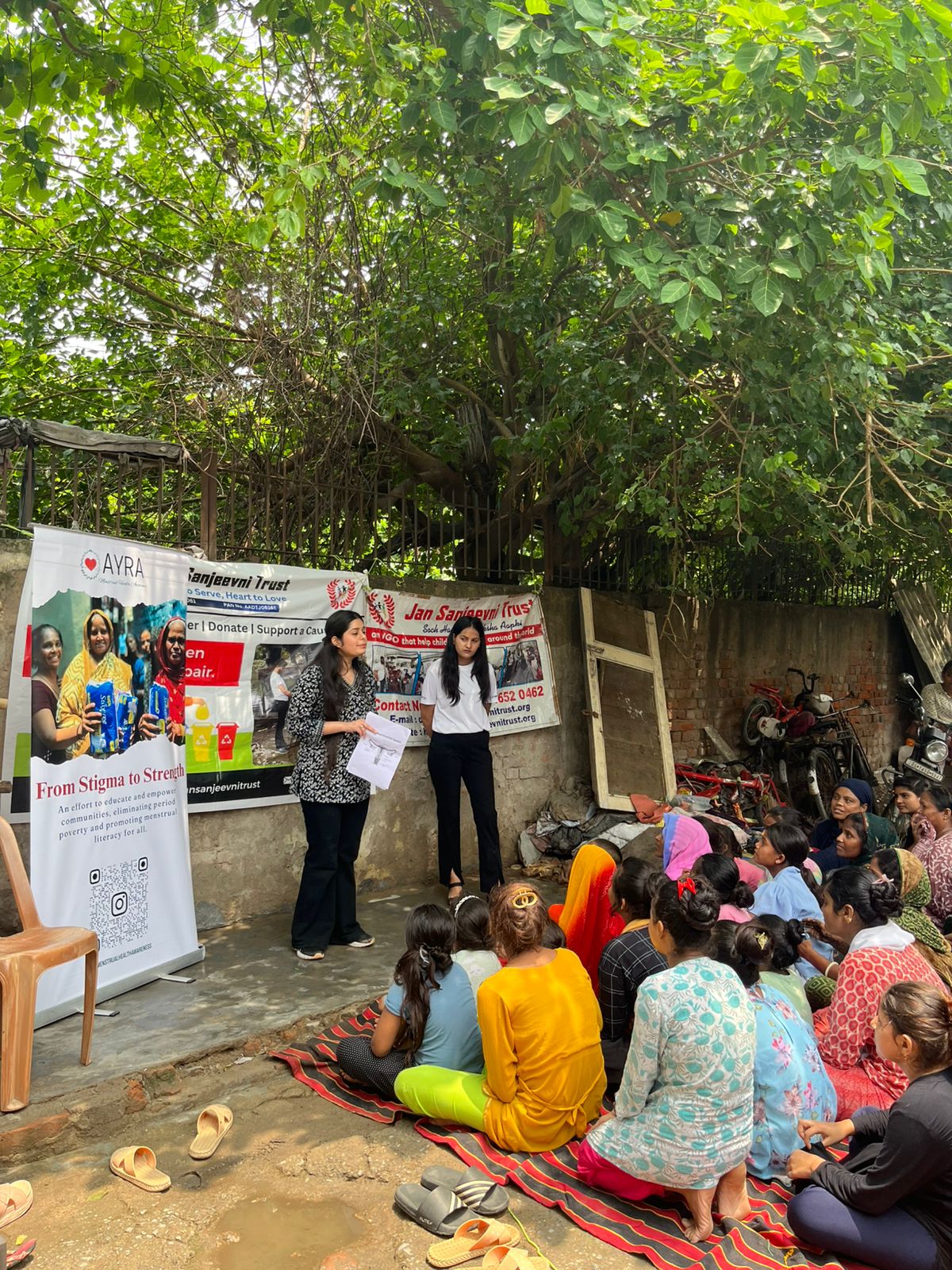 NGO volunteers conducting sanitary pad awareness workshop in community